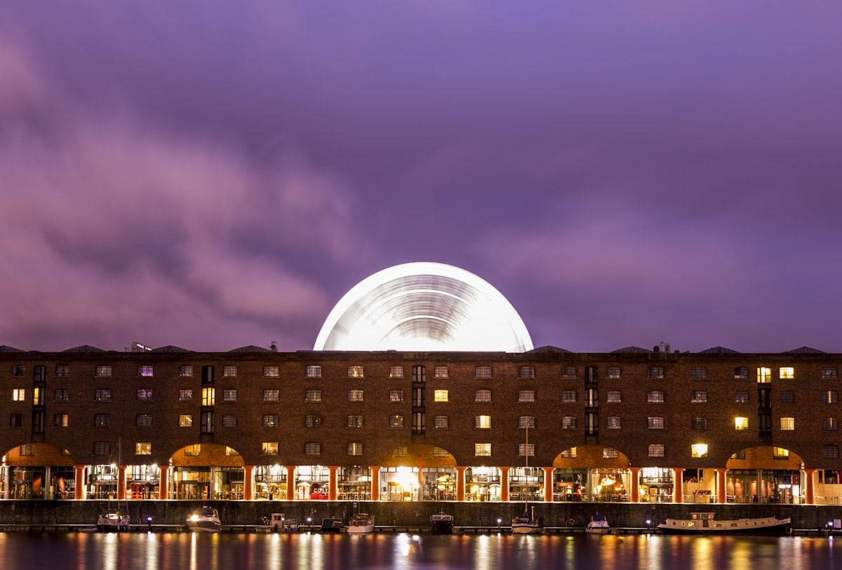 a large building with a ferris wheel in the background