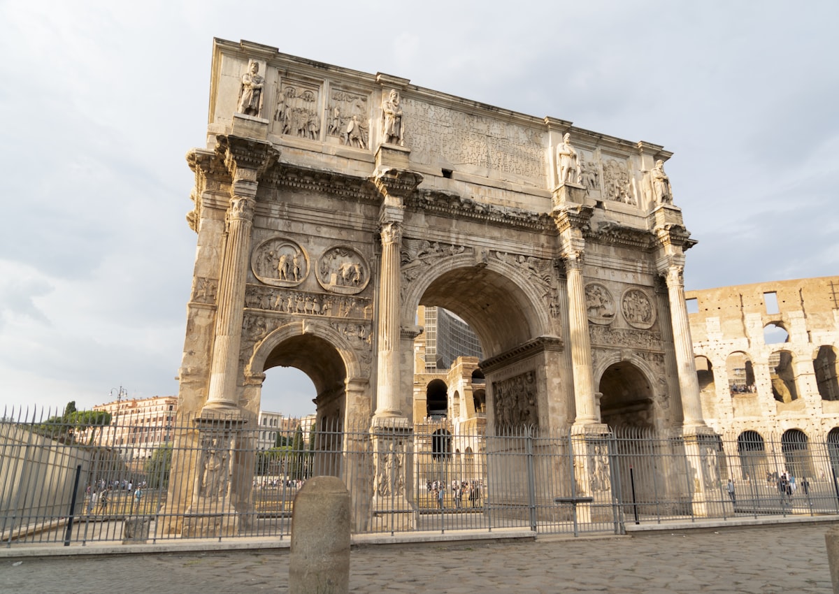 a large stone building with a fence around it