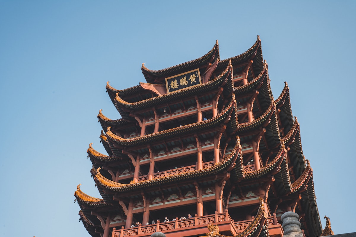 brown and black pagoda temple under blue sky during daytime