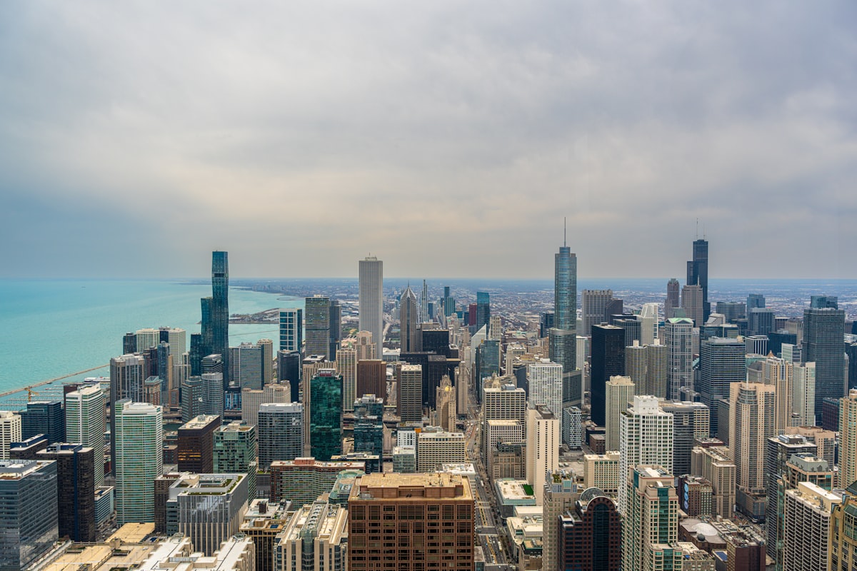 Aerial view of a sprawling cityscape with a distant ocean.