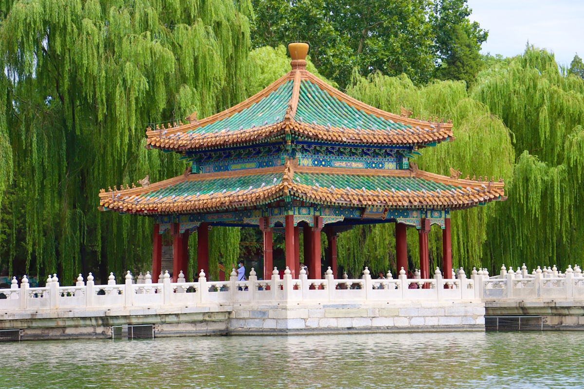 a building with a red roof surrounded by water