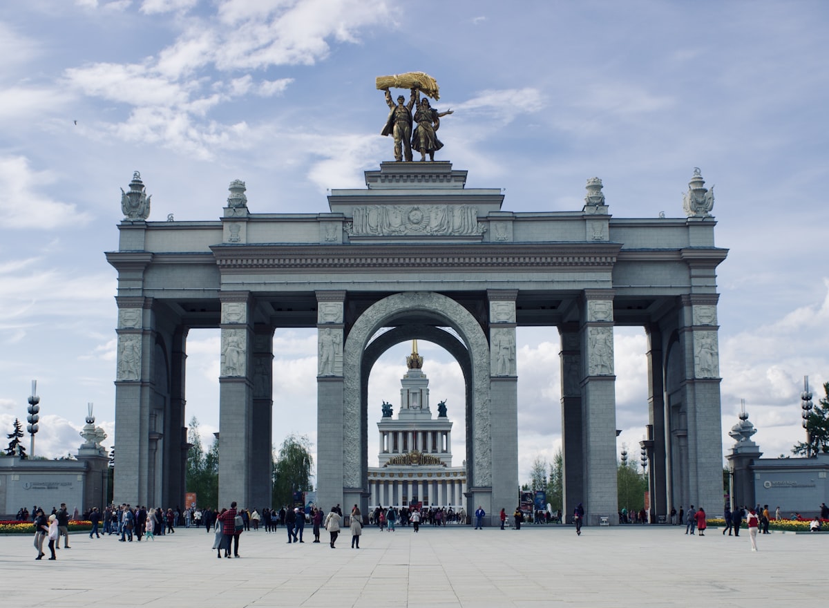 a group of people standing in front of a monument