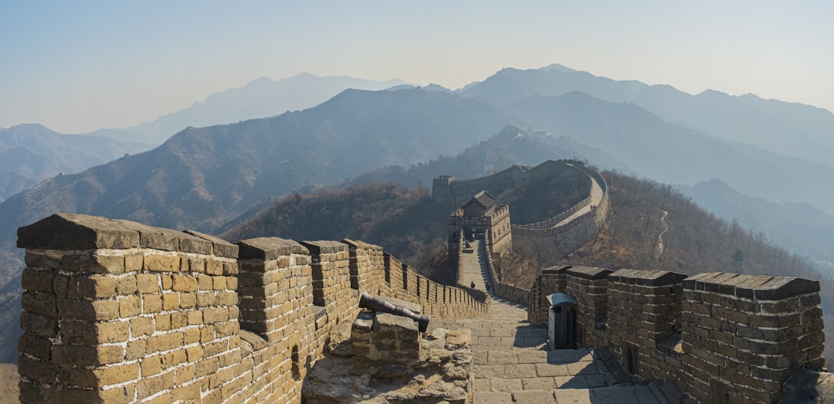 the great wall of china with mountains in the background