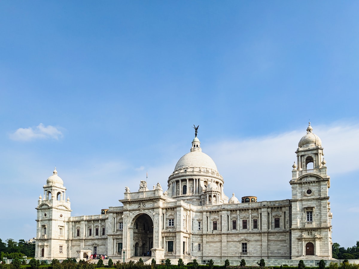 a large white building with a statue on top of it