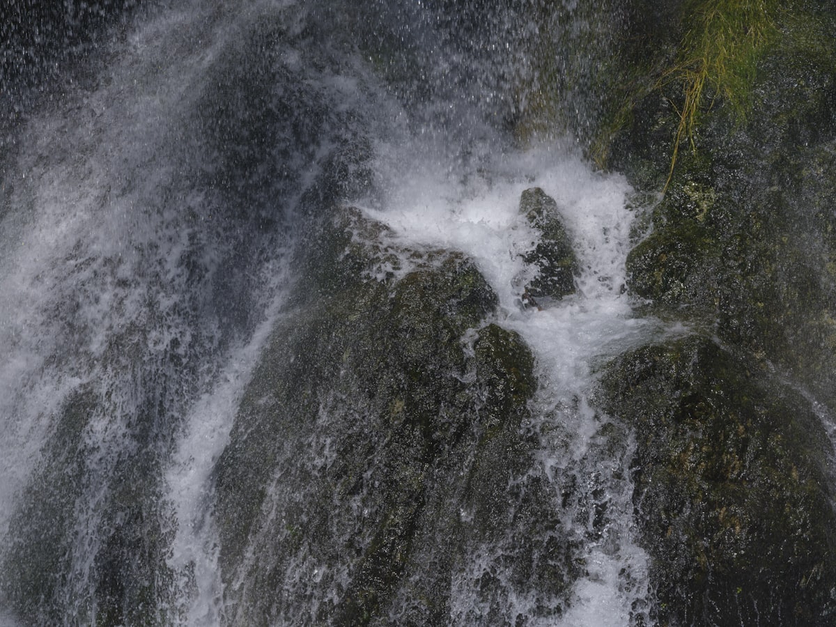 Water cascades down a rocky waterfall.