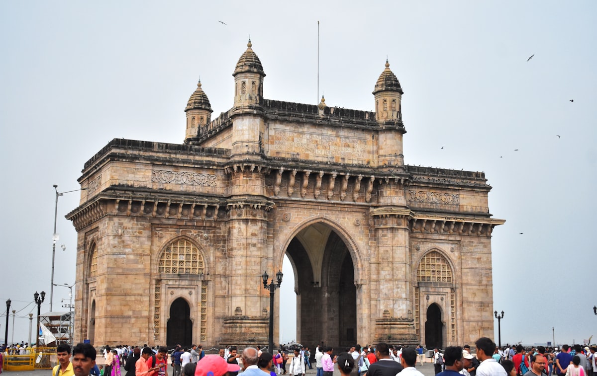 people in front of brown concrete building during daytime