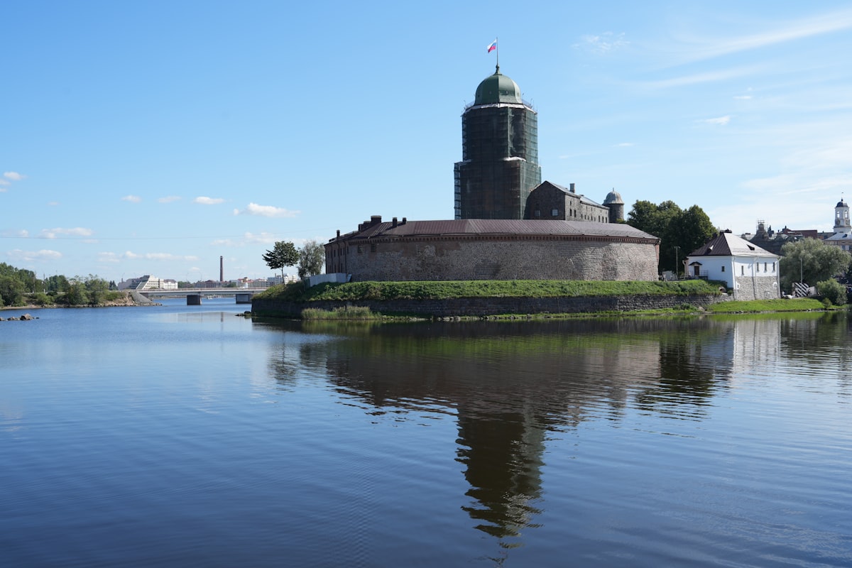 A body of water with a building in the background