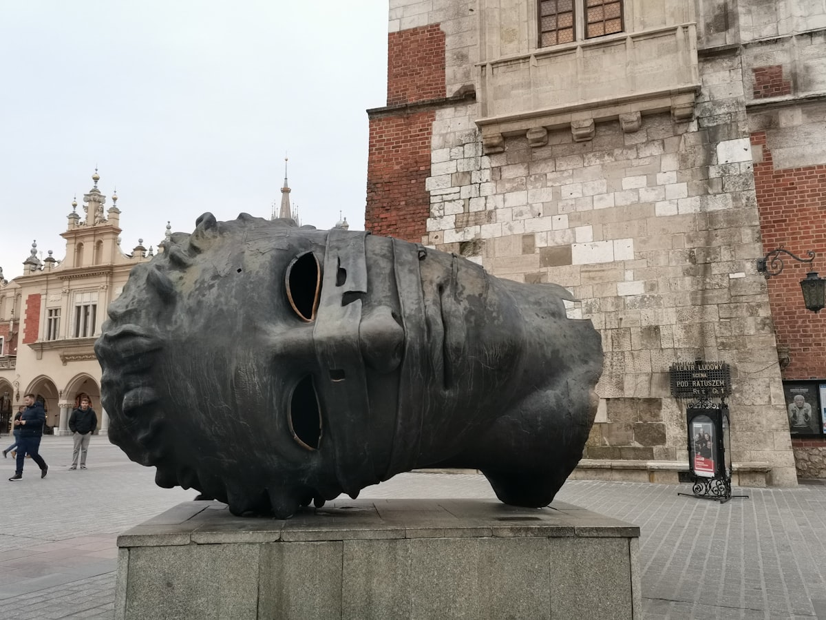 a large piece of art sitting on top of a cement block
