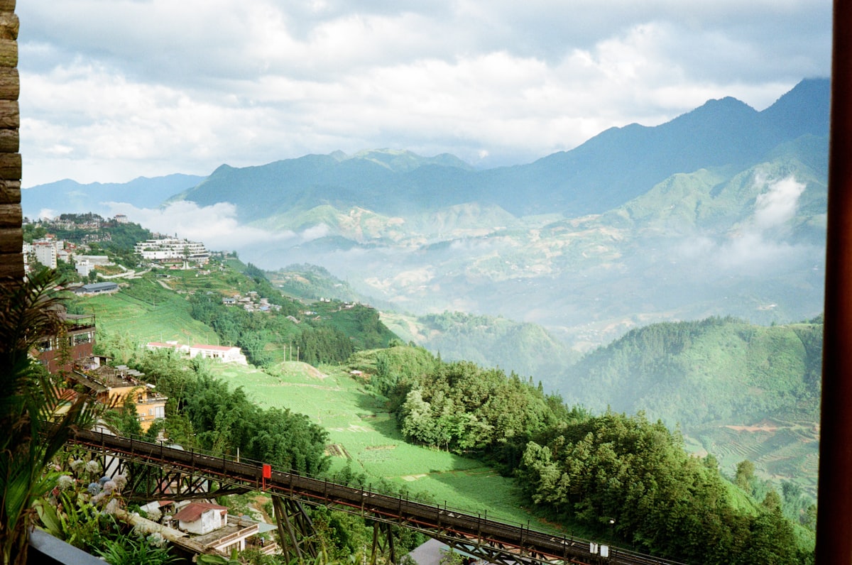 Rolling green hills and misty mountains in the distance.