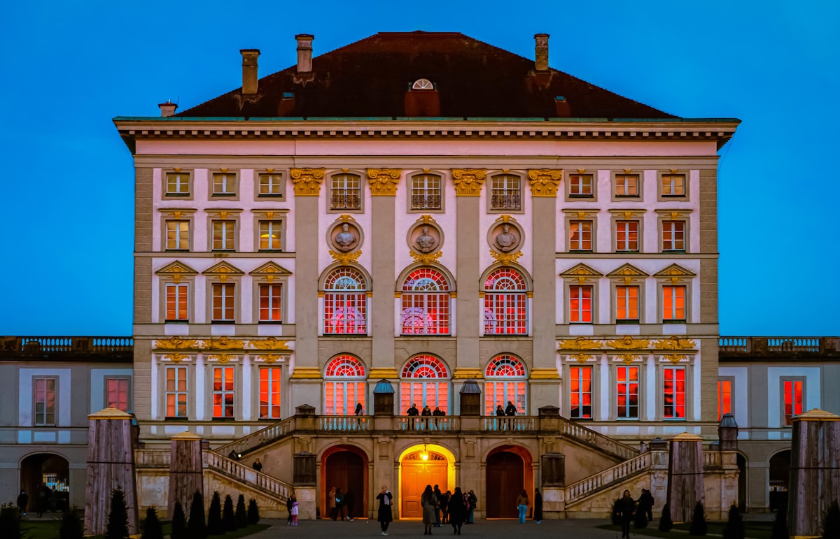 A large building with many windows lit up at night