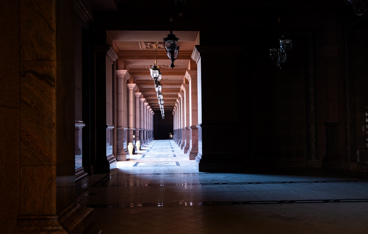 A long hallway with a clock hanging from the ceiling