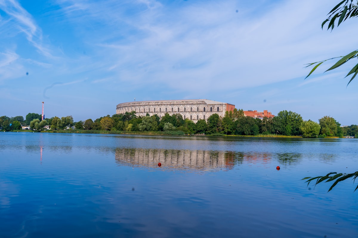 A body of water with a building in the background