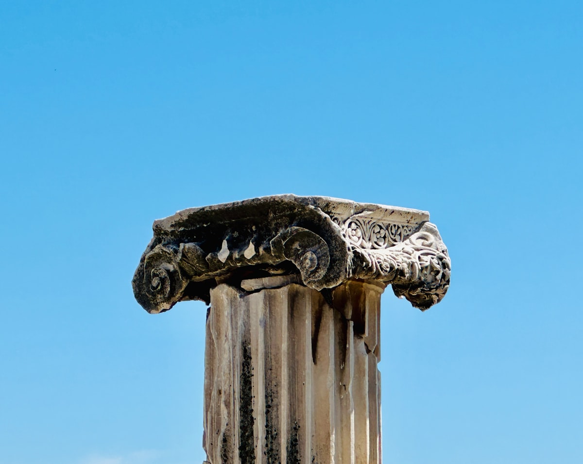 A close up of a column with a sky in the background