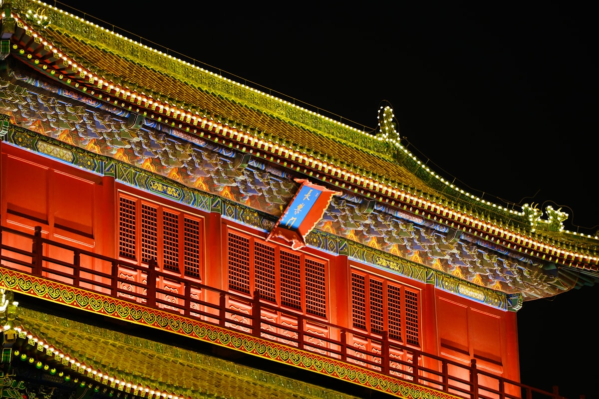 Ornate building with red walls and yellow lights at night