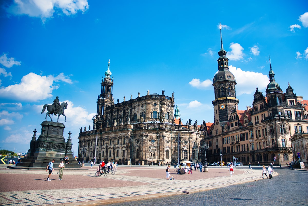 Historic square with ornate buildings and a statue.
