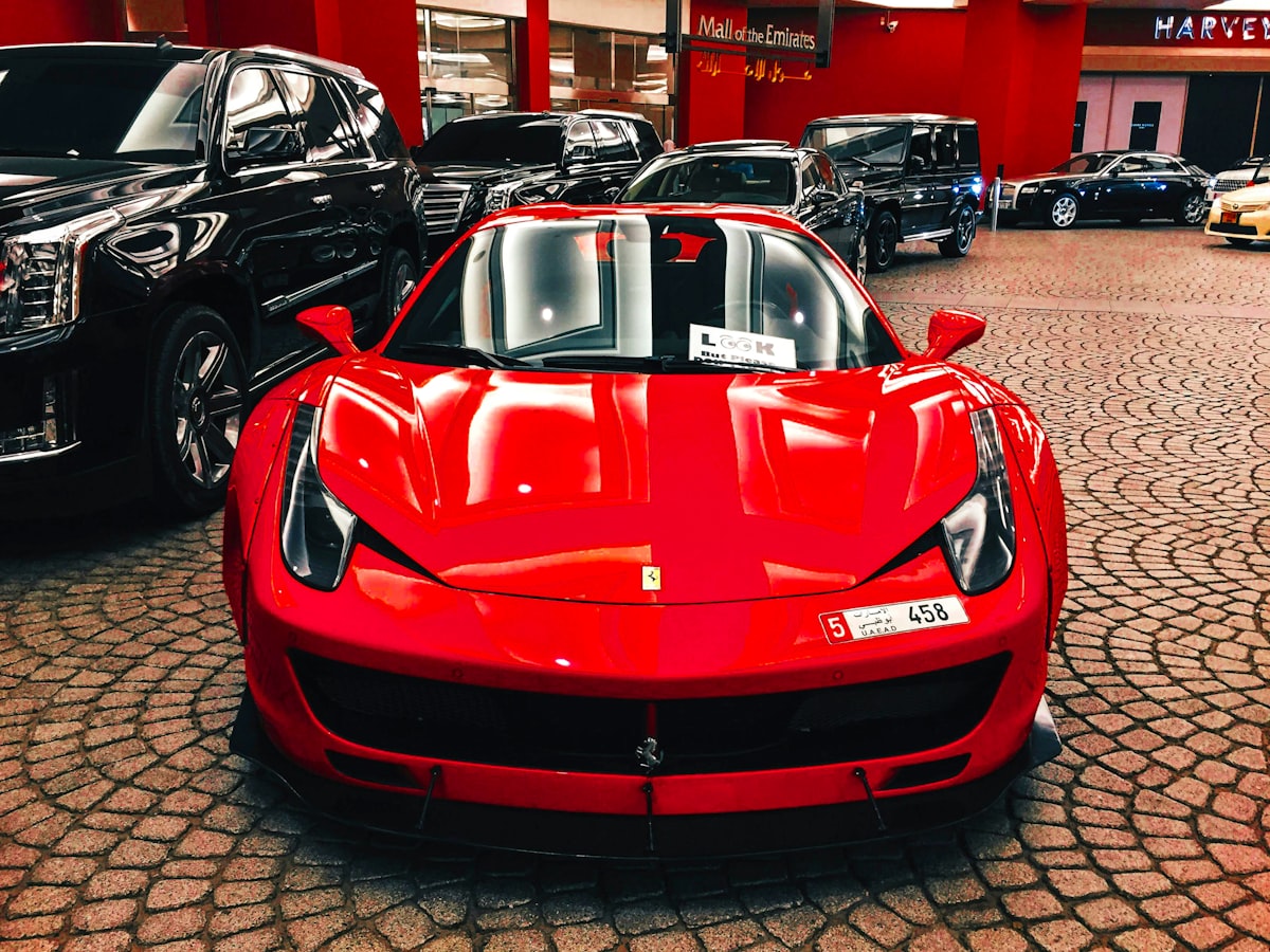 A red sports car is parked in a showroom
