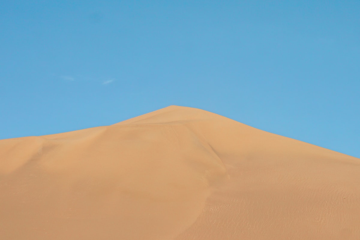 brown sand under blue sky during daytime