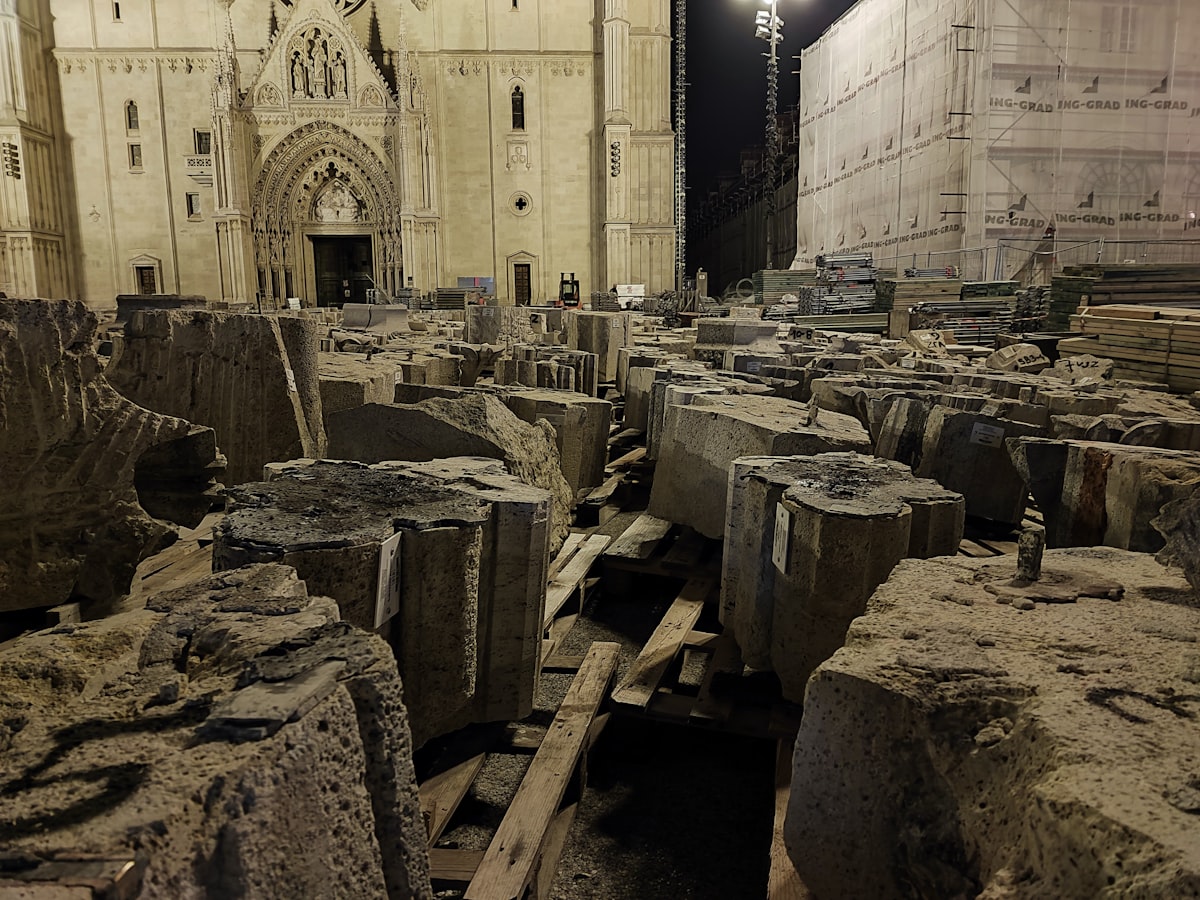 a large group of rocks sitting in front of a building