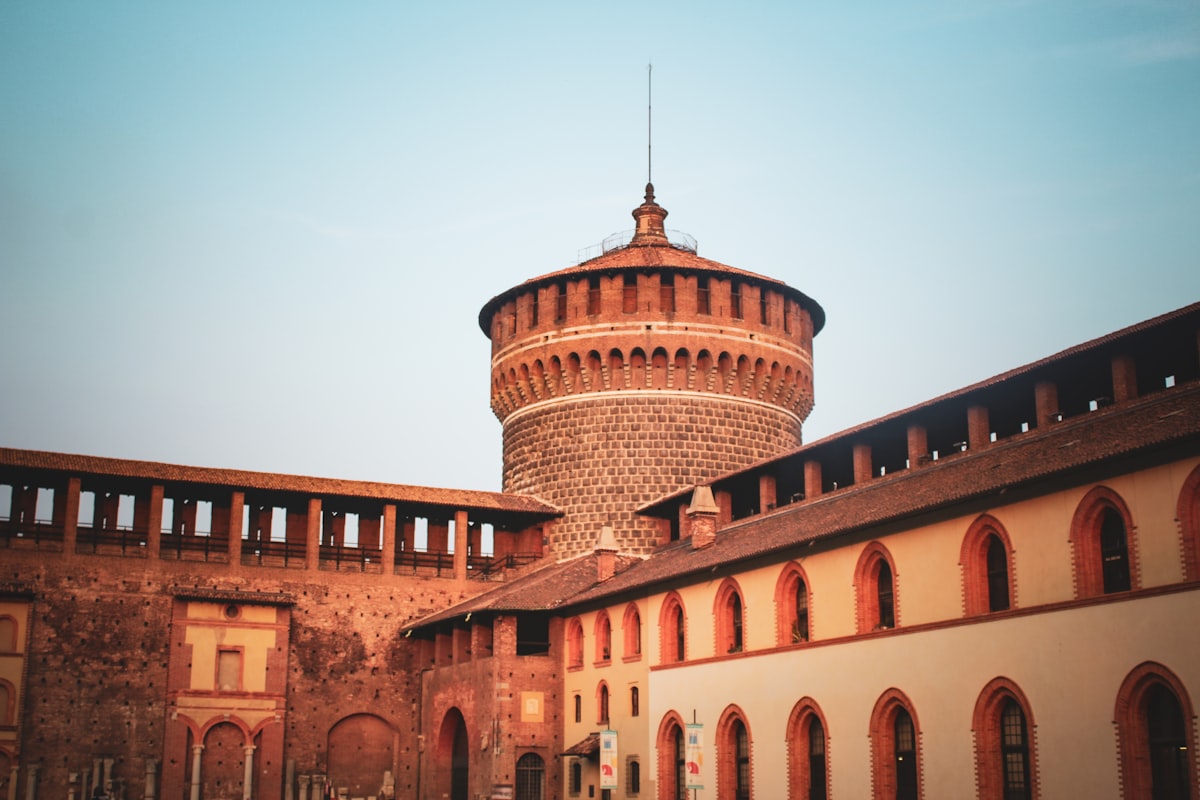 an old brick building with a water tower in the background