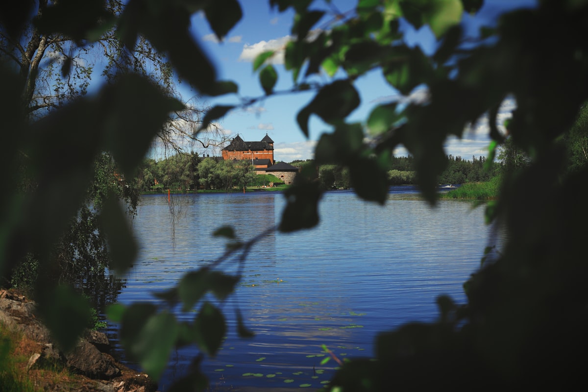 A body of water with a building in the background