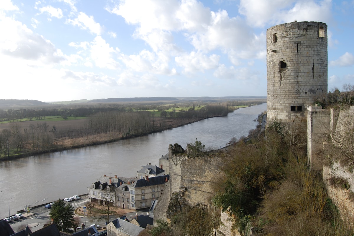 a stone tower next to a river