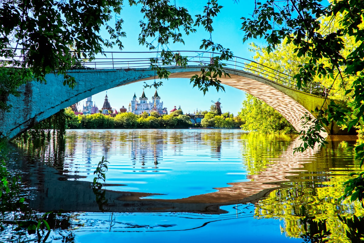 A bridge over water reflects beautiful buildings.