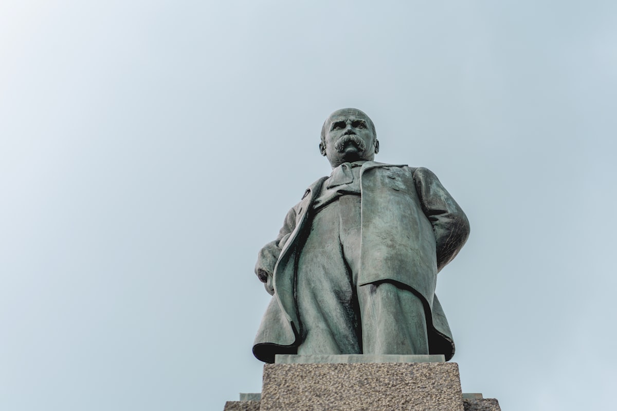 A bronze statue stands tall against the sky.