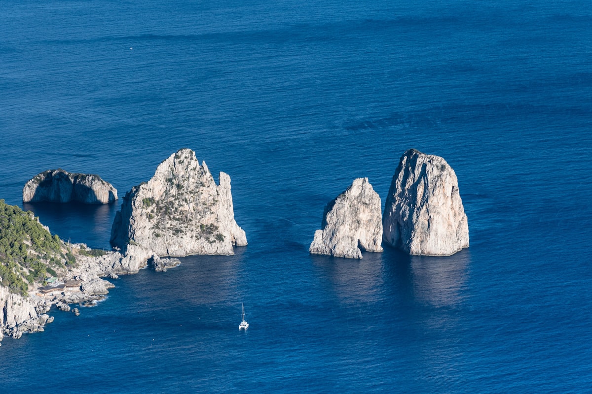 a group of rocks sitting in the middle of a body of water