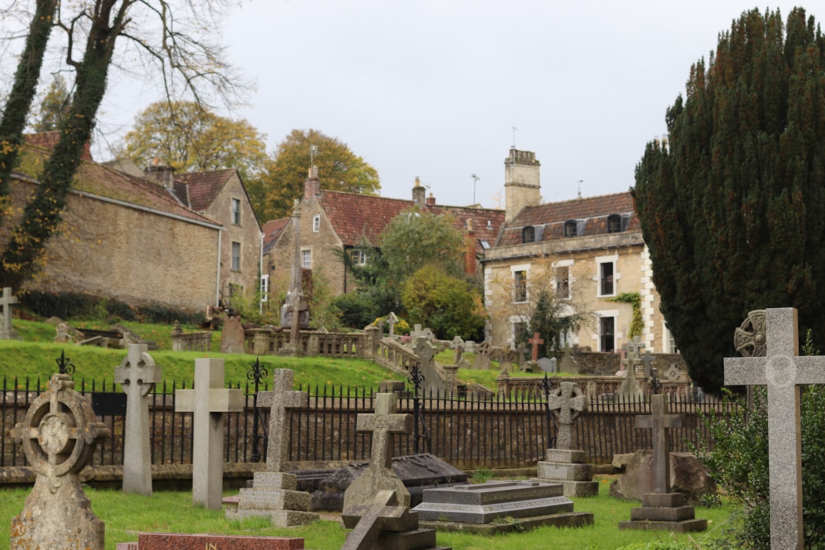 Old gravestones and buildings on a cloudy day