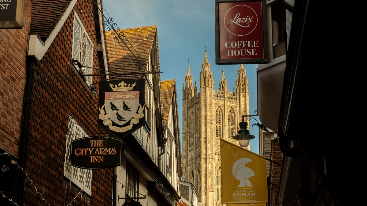 Street with inns and a church tower in the distance