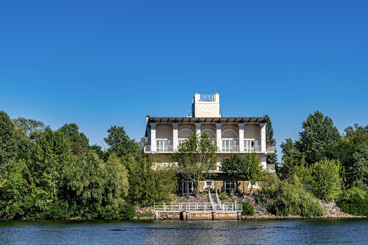 a house sitting on top of a lush green hillside