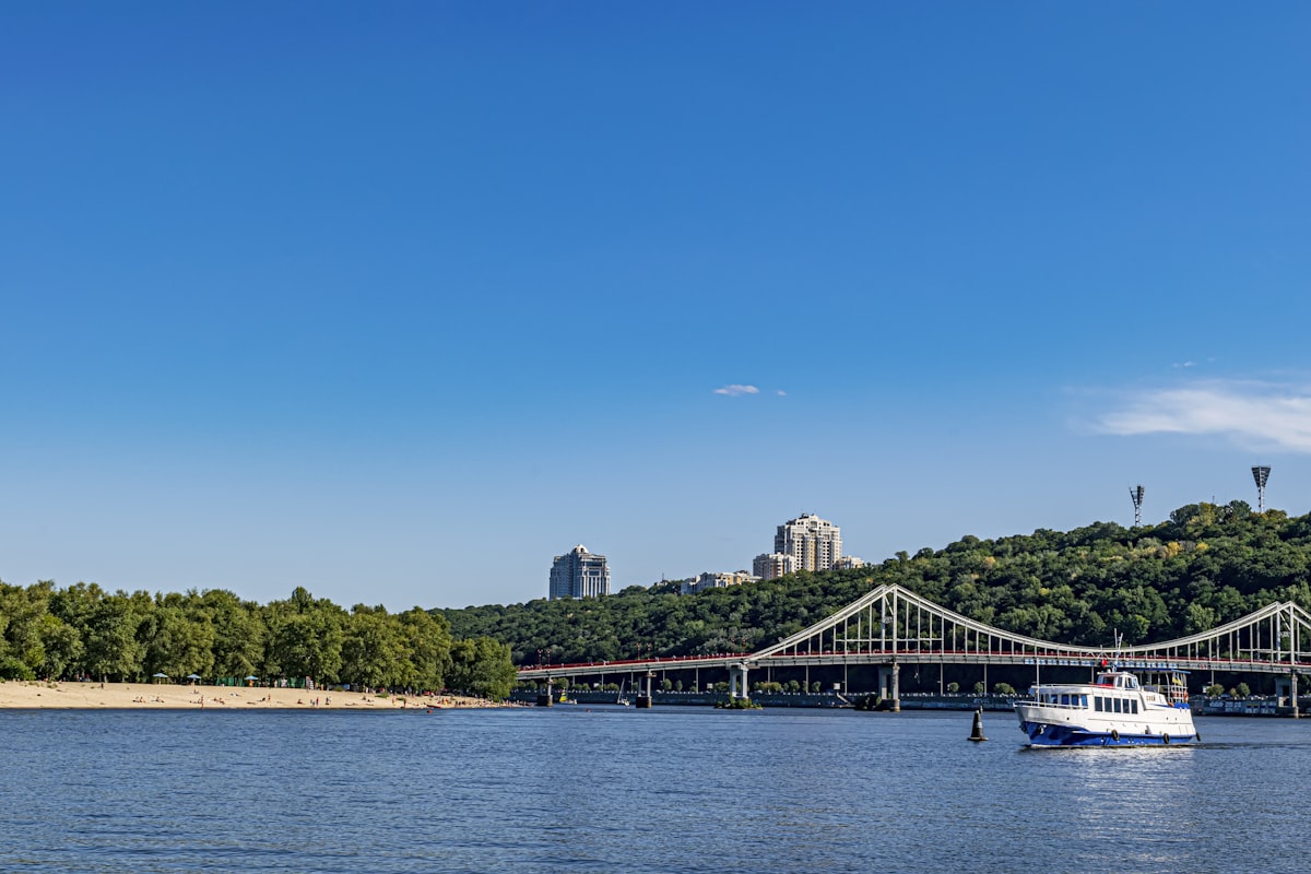 a boat on a body of water near a bridge