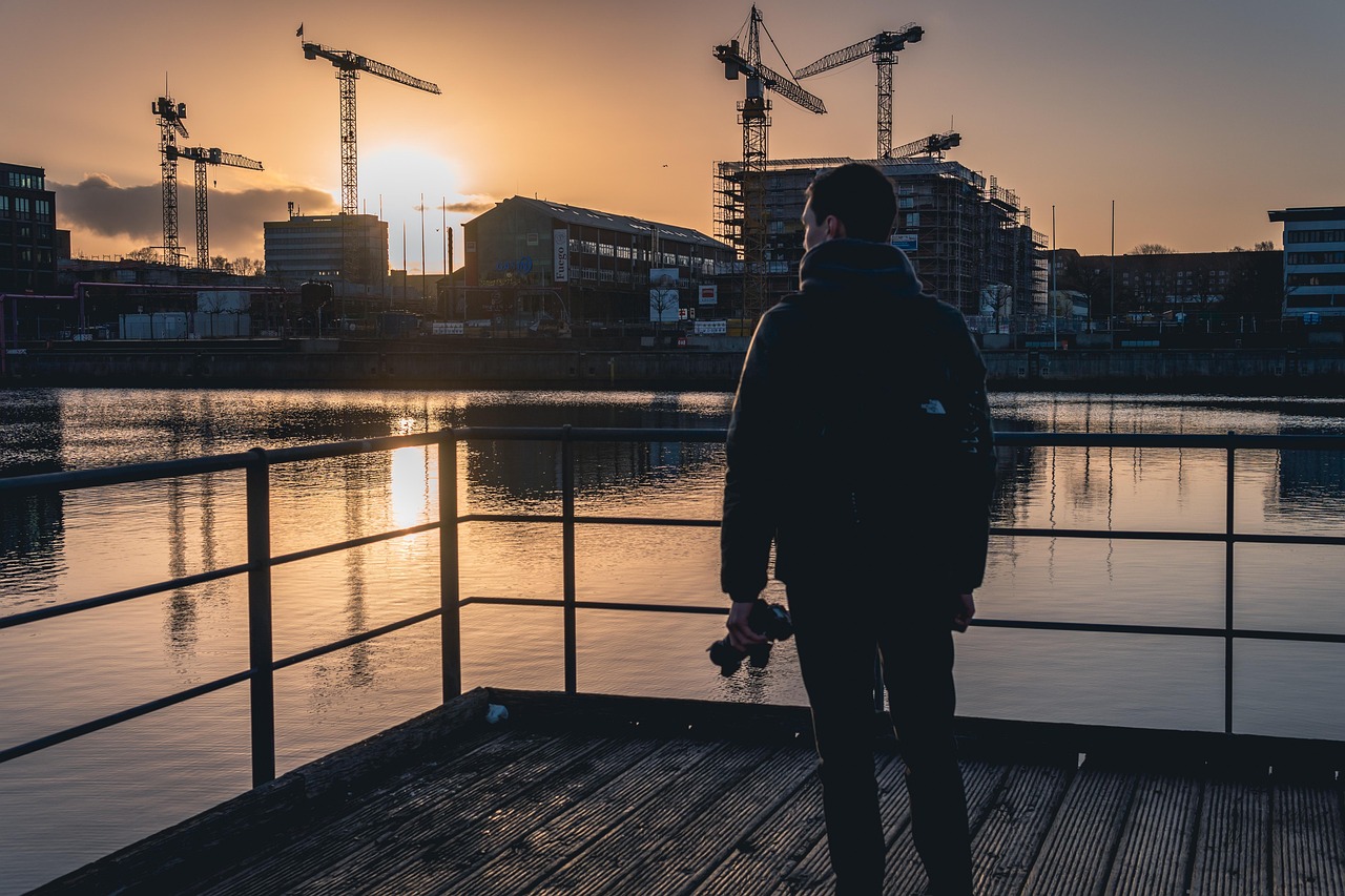 photographer, kiel, sunrise, urban, cranes, construction site, sea, water, nature, fjord, winter, man, human, thoughtful, throughts, person, orange, the atmosphere
