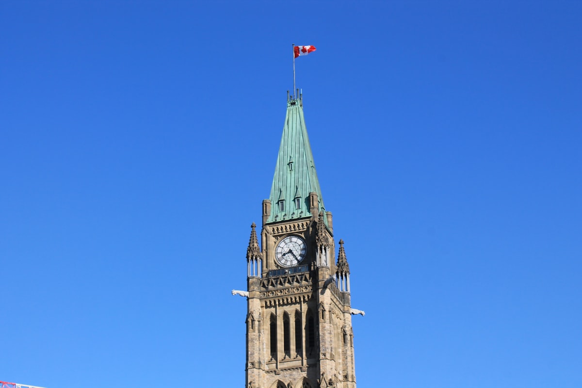 a tall clock tower with a flag on top