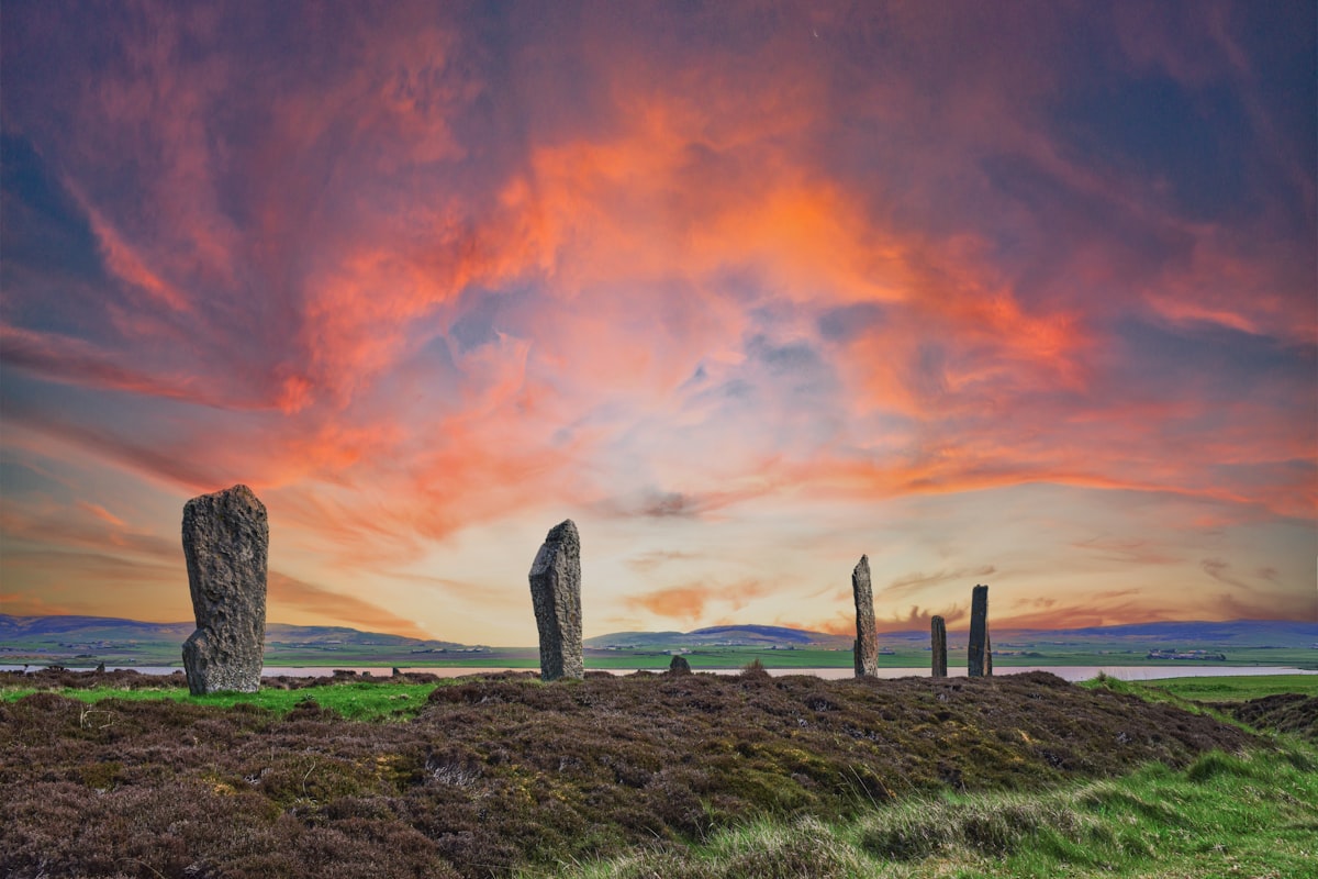 A group of stones sitting on top of a lush green field