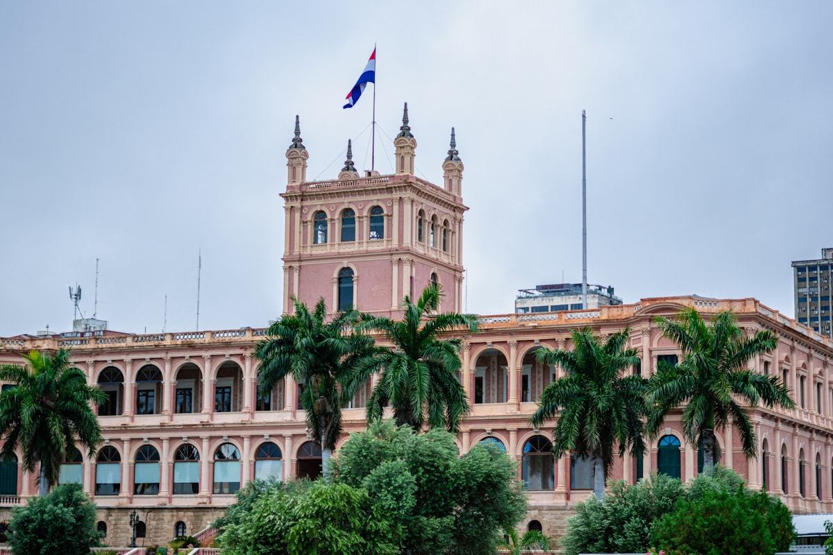 a large building with palm trees in front of it