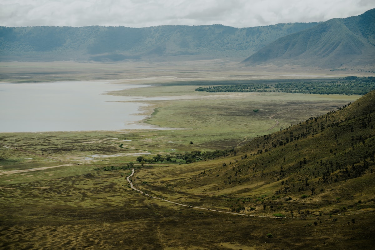 Vast landscape with lake and mountains visible.