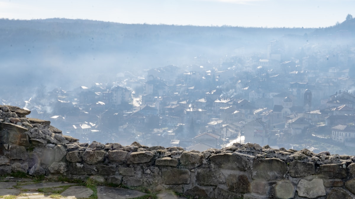 a view of a city from a stone wall