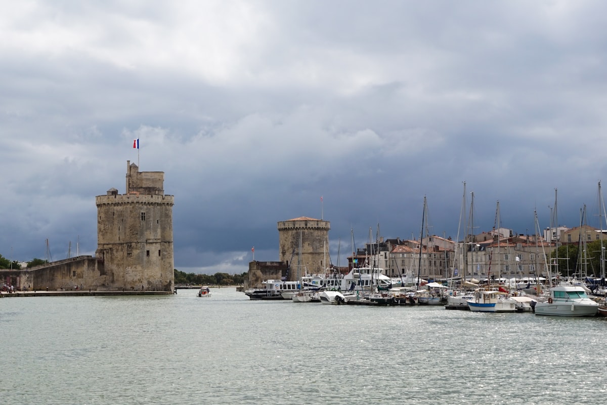 brown concrete building near body of water during daytime