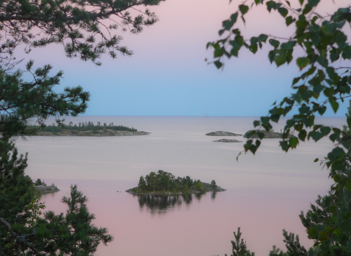 calm body of water under blue sky