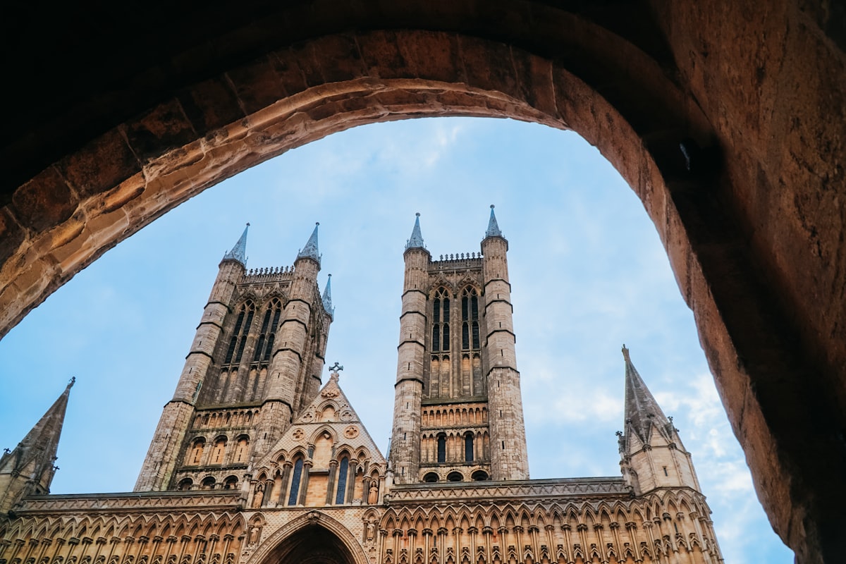 Gothic cathedral towers seen through stone archway