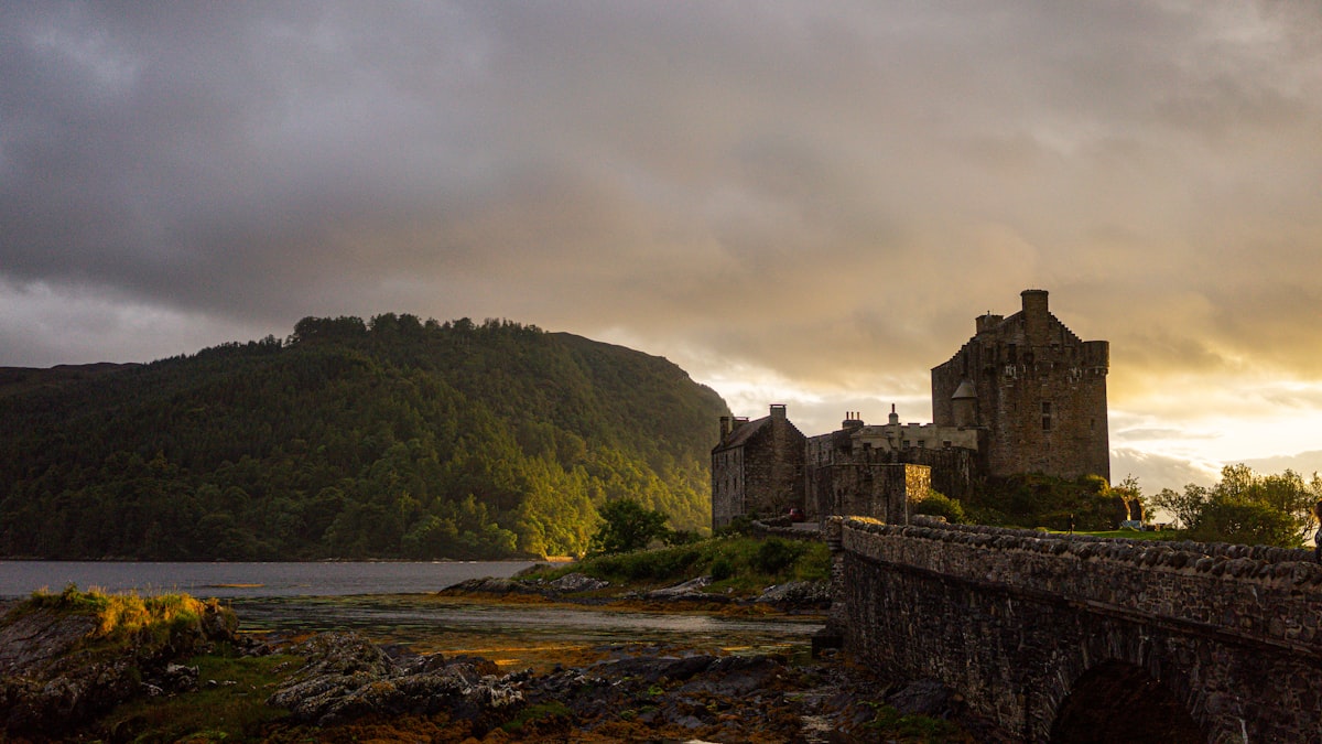 A stone bridge with a castle in the background