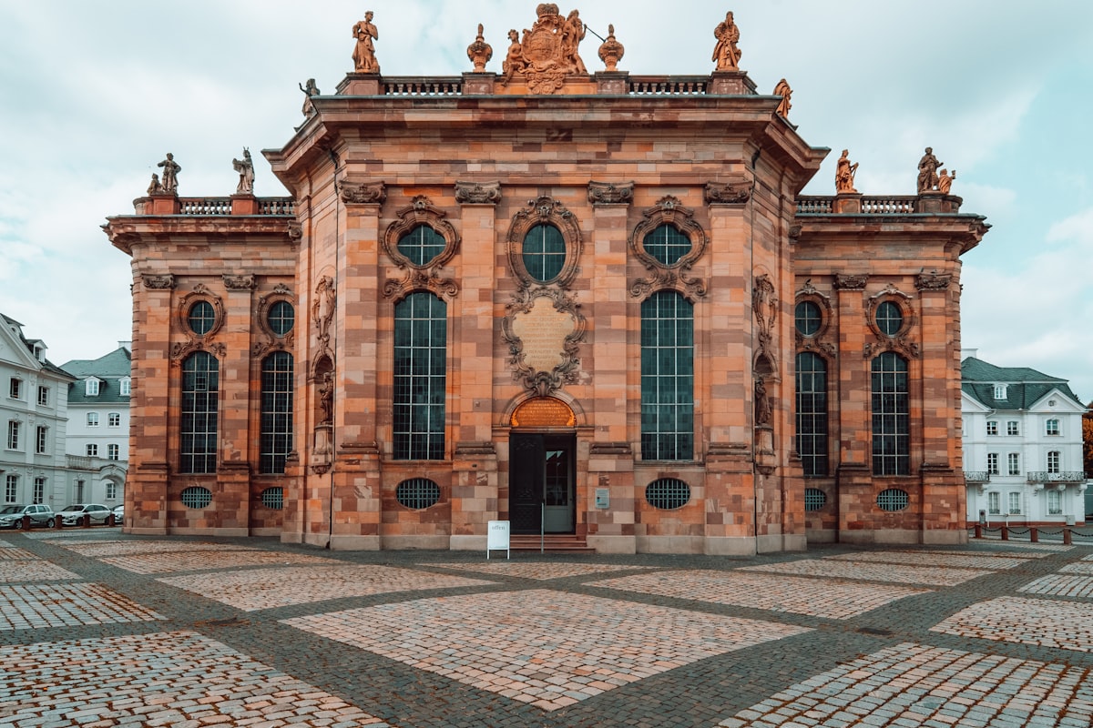 a large building with many windows and statues on top of it