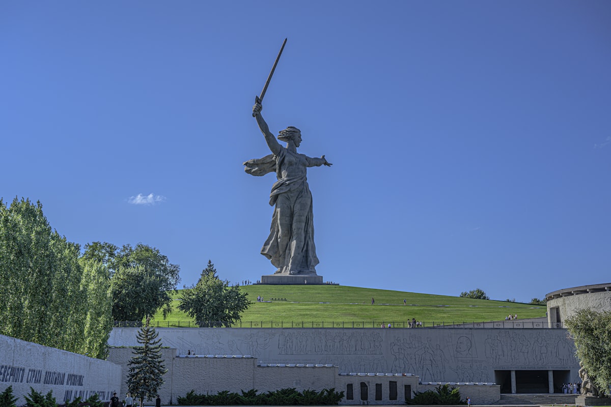 a statue of a woman holding a sword in front of a building