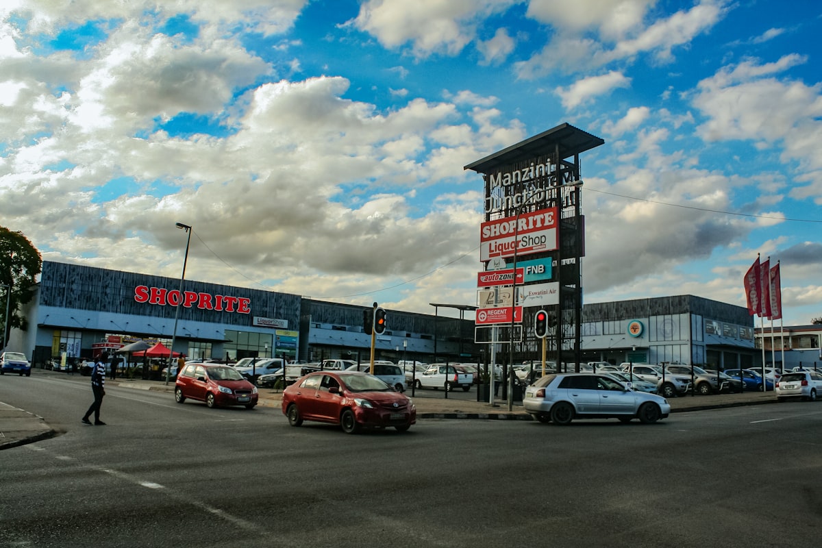 A busy street in front of a shopping center.