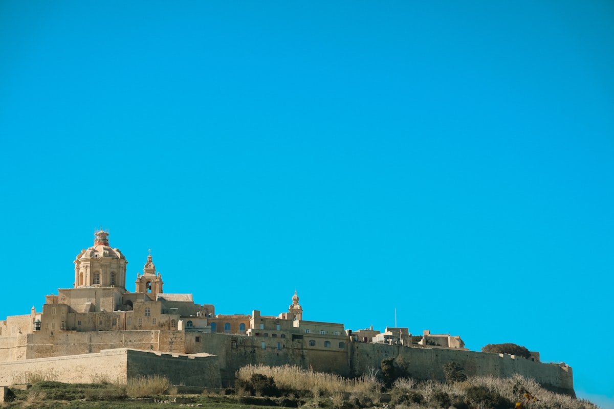 Ancient stone buildings on a hill under clear blue sky