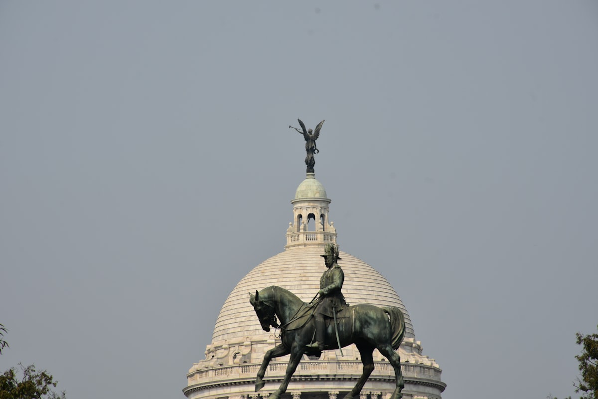 a statue of a person on a horse in front of a building
