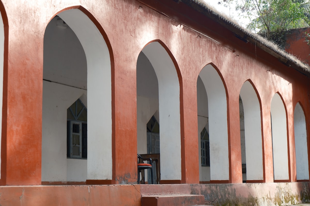 Red building with arched windows and white trim