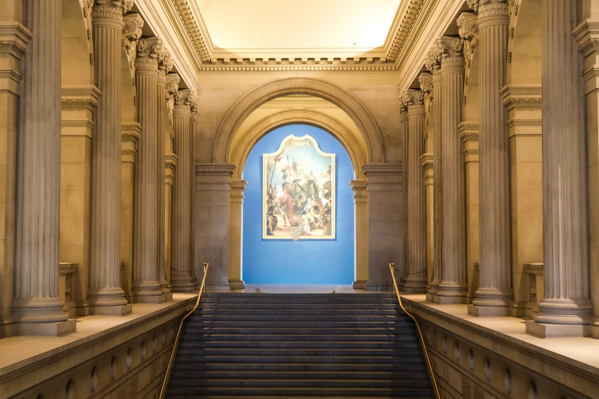 Grand staircase in a classical building with artwork