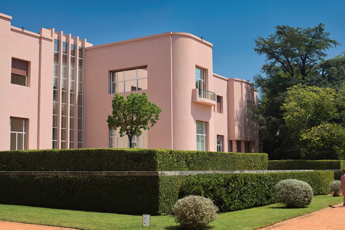 Pink art deco building with manicured gardens